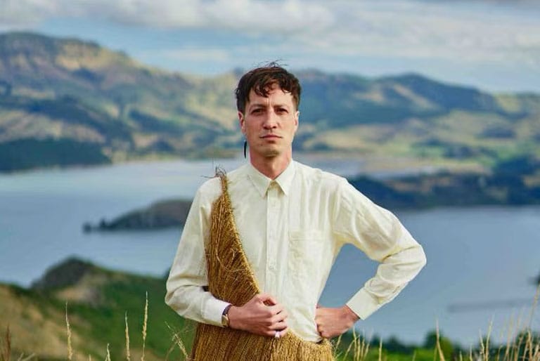 Marlon Williams Marlon Williams standing in an outdoor setting with mountains in the background. He is wearing traditional New Zealand clothing.