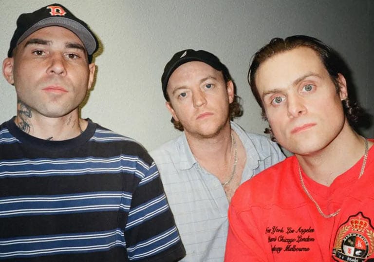 DMA’S band members posing together for a close-up portrait in casual clothing.