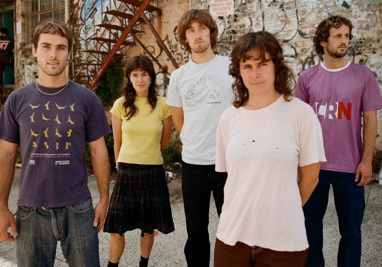 Floodlights Floodlights band members standing outside in an urban setting wearing casual clothes