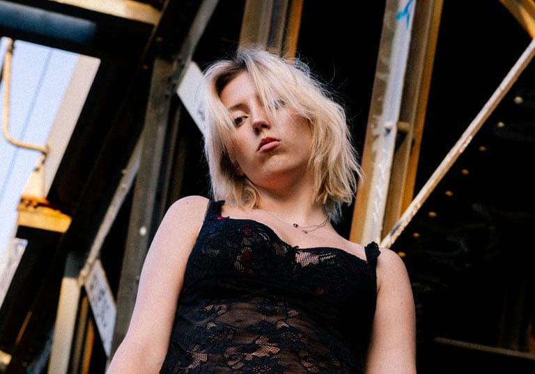 Portrait of Lotte Gallagher in an industrial setting.