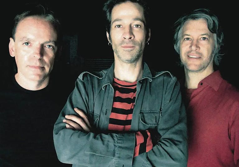 Ratcat band members standing in front of a black wall