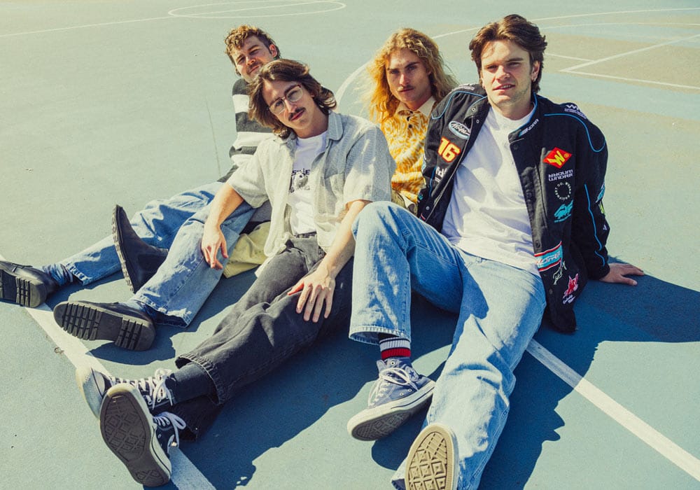 Teenage Dads in casual clothes sitting on a basketball court