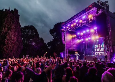 Sneaky Sound System performing at Live at the Gardens Melbourne. The crowd is dancing with their hands in the air, having a great time!